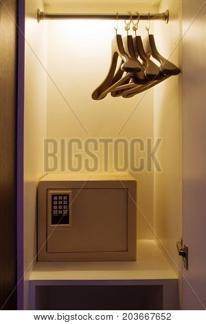 safe box hidden in low light wardrobe.