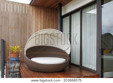 The wicker furniture at wooden terrace. Furniture for relaxation.
