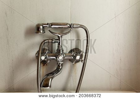 Shiny taps on marble wall. Cold and hot water faucet.