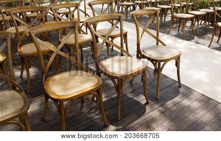 Wooden chairs set row orderly on the terrace.