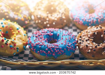 Colorful donuts in different colors in a whicker basket