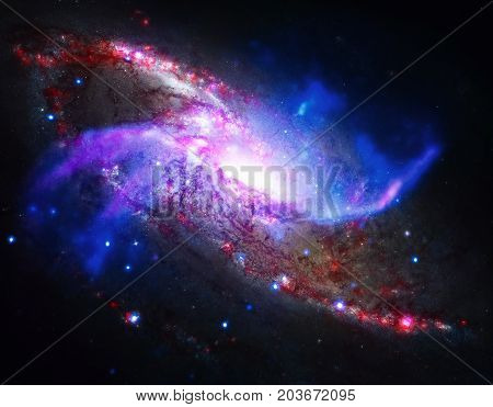 Spiral galaxy M106. It located in the constellation Canes Venatici. NGC 4258 is a spiral galaxy like the Milky Way. Retouched colored image. Elements of this image furnished by NASA.