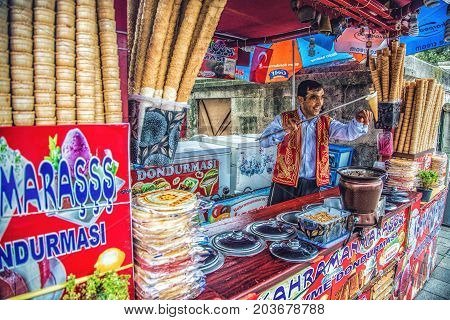 ISTANBUL, TURKEY: Dondurma ice-cream seller dressed in traditional Turkish costume in the street shop on October 4, 2014