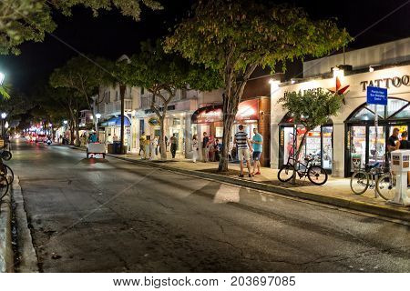 KEY WEST, FLORIDA, USA - JAN 18, 2017: Shops, bars and hotels in the twilight at Duval street in the center of Key West