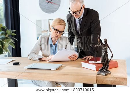 Mature Lawyers With Paperwork