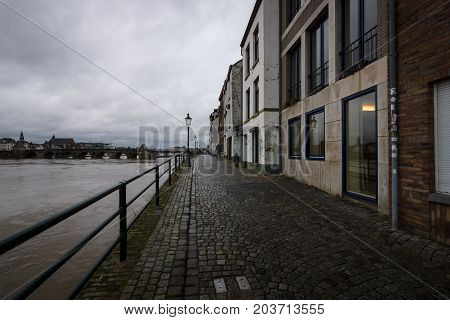 MAASTRICHT NETHERLANDS - JANUARY 09 2015: View of Maastricht city centre with its partly medieval bridge on the Meuse river. Maastricht is the oldest city of the Netherlands and the capital city of the province of Limburg.