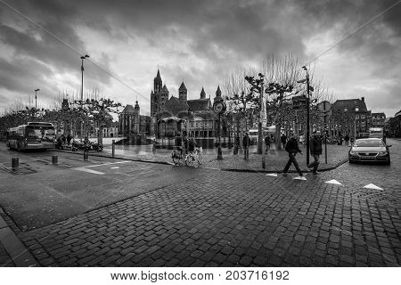 MAASTRICHT NETHERLANDS - JANUARY 09 2015: Vrijthof square. In the background Evangelical Church of John the Baptist and the Basilica of Saint Servatius. Black and white.