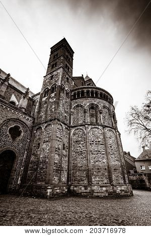 MAASTRICHT NETHERLANDS - JANUARY 09 2015: Vrijthof square. Basilica of Saint Servatius. Vintage toning. Stylization. Maastricht is the oldest city of the Netherlands and the capital city of the province of Limburg.