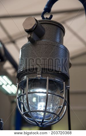Industrial explosion-proof lantern of black and gray shines with white light at coal mining exhibition