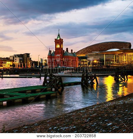 Cardiff UK. Waterfront at night in Cardiff UK. Sunset colorful sky with Wales Millennium Center at Cardiff Bay. Colorful water