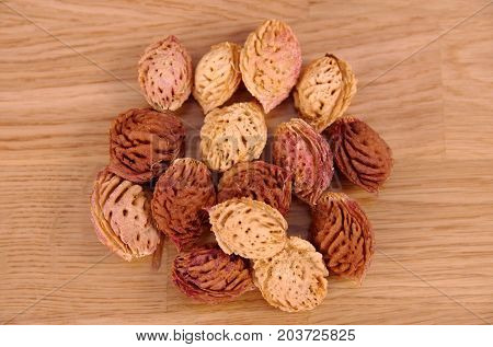 Peach seeds on wooden table. Wop view.