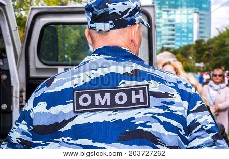 Samara Russia - September 10 2017: Russian police officer in uniform of Special Purpose Mobile Unit (OMON). Russian SWAT. Text in russian: 