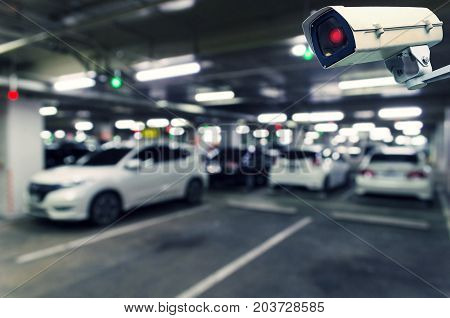 CCTV security indoor camera system operating with blurred image of under ground indoor car parking garage area RFID solution management system surveillance security and safety technology concept