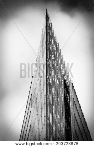 BERLIN - FEBRUARY 22 2015: Detail of a modern building Neues Kranzler Eck on the famous shopping street - Kurfuerstendamm. Black and white. Stylization. Large grains.