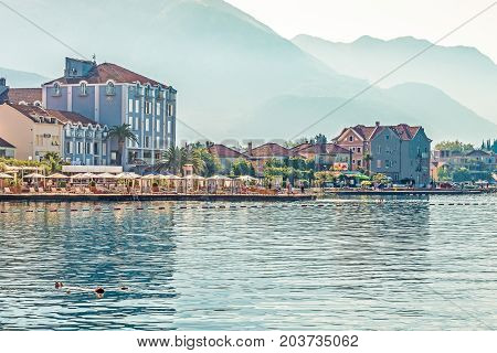 TIVAT, MONTENEGRO - August 24, 2017: View of the beautiful beach in Tivat on the shore of Kotor Bay. Tivat is a famous resort in Montenegro.