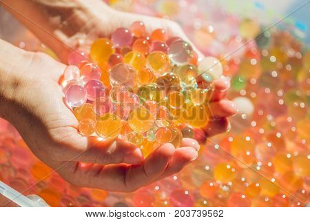 Colored Balls Of Water Beads, Hydrogel In In Hands. Sensory Experiences