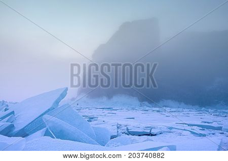 Field of blue ice and rocks Hoboy in the fog. Russia. Lake Baikal