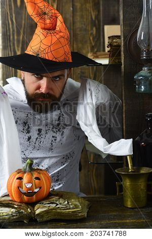 Man With Beard On Wooden Background. Man In Orange Hat