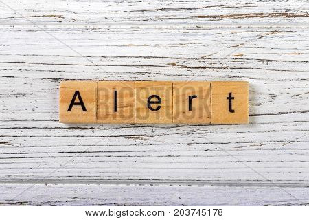 ALERT word made with wooden blocks concept