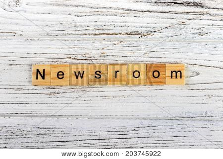 NEWSROOM word made with wooden blocks concept