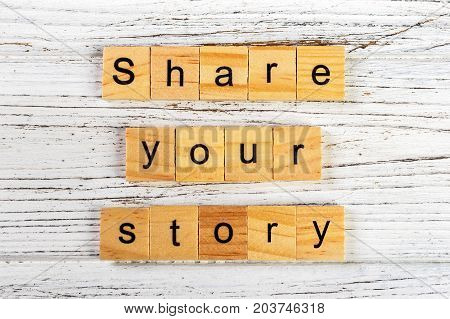 share your story word made with wooden blocks concept