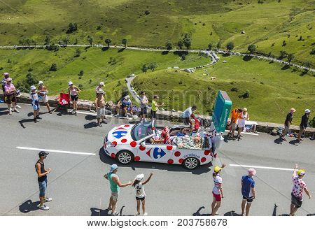 Col de PeyresourdeFrance- July 23 2014: Carrefour vehicle passing in the Publicity Caravn on the road to Col de Peyresourde in Pyrenees Mountains during the stage 17 of Le Tour de France 2014.
