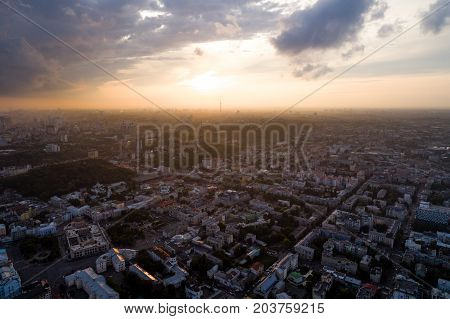 Panoramic view of a modern city at sunset. Skyline bird eye aerial view of the old part of the city - Podol district under dramatic cloud sunset sky. Kiev. Ukraine