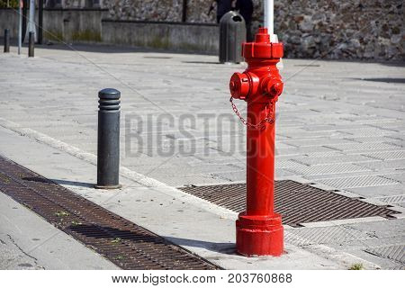 Old red fire hydrant in New York City street. Fire hidrant for emergency fire access .