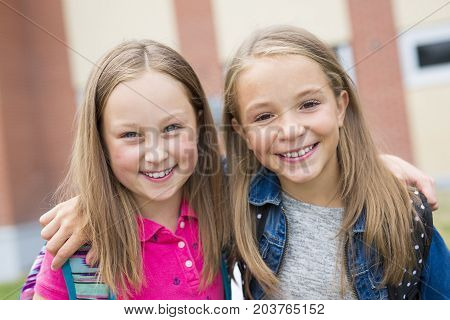 The Great Portrait Of School Pupil Outside Classroom Carrying Bags