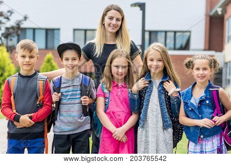 The Great Portrait Of School Pupil Outside Classroom Carrying Bags