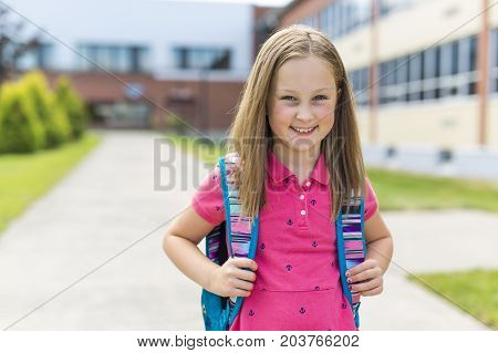 The Great Portrait Of School Pupil Outside Classroom Carrying Bags