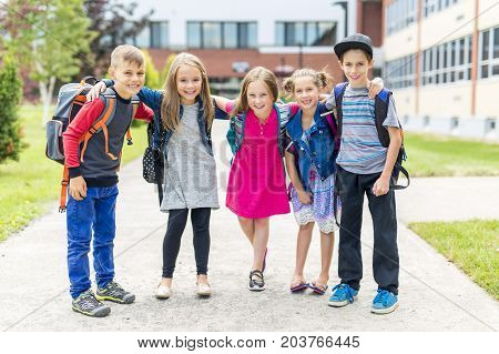 The Great Portrait Of School Pupil Outside Classroom Carrying Bags