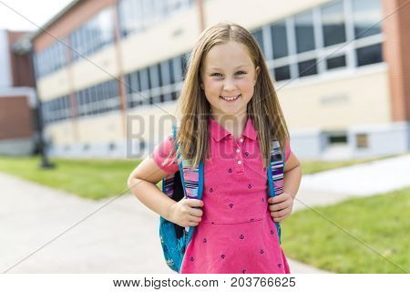 The Great Portrait Of School Pupil Outside Classroom Carrying Bags