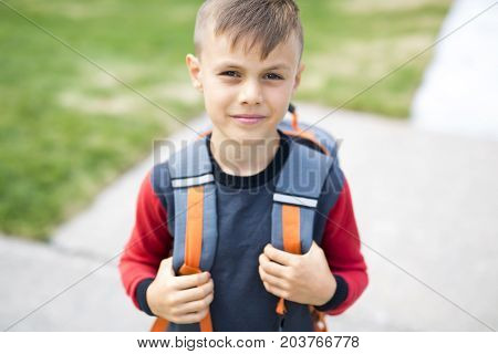 The Great Portrait Of School Pupil Outside Classroom Carrying Bags