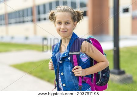 The Great Portrait Of School Pupil Outside Classroom Carrying Bags