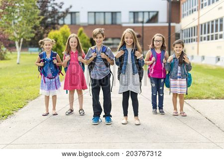 The Great Portrait Of School Pupil Outside Classroom Carrying Bags