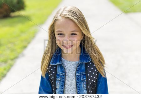 The Great Portrait Of School Pupil Outside Classroom Carrying Bags