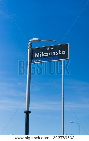 Street sign on pole of the Ulica Milczanska and a blue sky on August 2017 in Poznan Poland