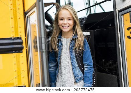 The Great Portrait Of School Pupil Outside Classroom Carrying Bags