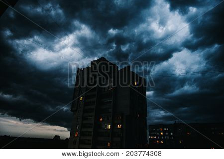 Storm clouds a hurricane is coming. Beautiful storm sky with clouds over the city apocalypse like