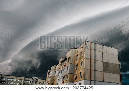 Storm clouds a hurricane is coming. Beautiful storm sky with clouds over the city apocalypse like