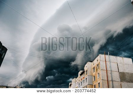 Storm clouds a hurricane is coming. Beautiful storm sky with clouds over the city apocalypse like