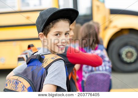 The Great Portrait Of School Pupil Outside Classroom Carrying Bags