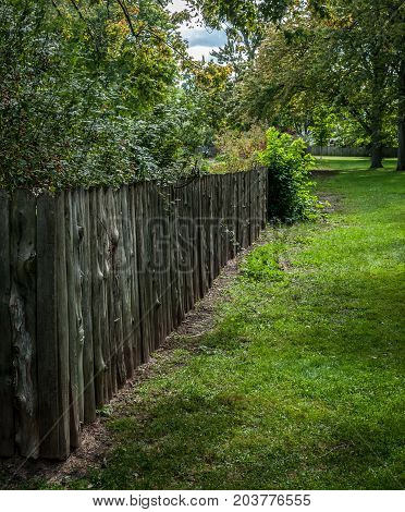 Dundurn Park Hamilton Ontario Canada. September 8 2017. Log fence and green grass. 2017