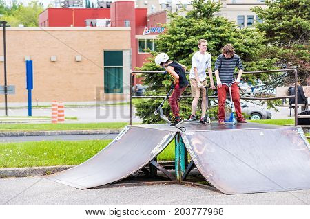 Saguenay, Canada - June 3, 2017: Downtown City Summer Park In Quebec With Young Teenagers Boys Skati