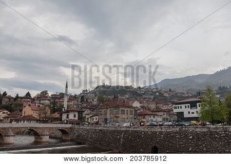 SARAJEVO BOSNIA AND HERZEGOVINA - APRIL 15 2017: Panorama of the left bank of Sarajevo in the old part of the city during a cloudy and rainy afternoon of spring. Sarajevo is the capital city of Bosnia and Herzegovina