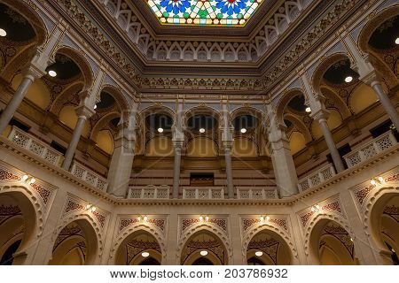 SARAJEVO BOSNIA AND HERZEGOVINA - APRIL 16 2017: Interior of the main hall of the Vijecnica the former library and city hall of Sarajevo destroyed during the 1991-1995 conflict and reconstruted characterized by its ottoman style