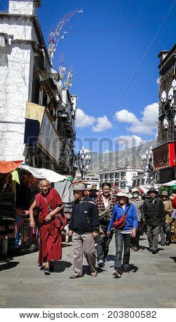 People Walk Around Jokhang Temple In Tibet