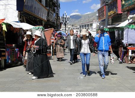 People Walk Around Jokhang Temple In Tibet