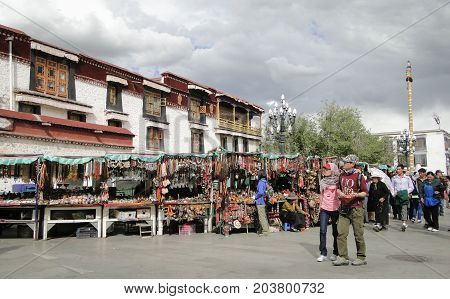 People Walk Around Jokhang Temple In Tibet